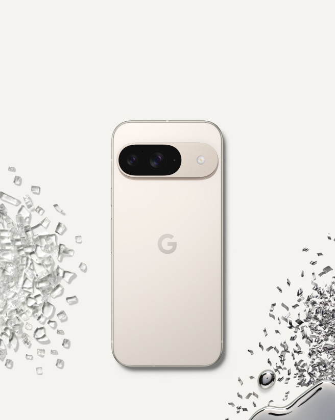 Back of Pixel 9 in Porcelain colour against a porcelain-coloured background, surrounded by glass and metal shards.